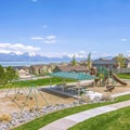 Square Houses and park with playground and picnic area on a neighborhood near a lake