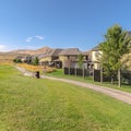 Square Houses and pathway along a golf course with scenic mountain and blue sky view