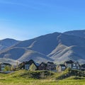 Square Houses on a terrain covered with grasses under blue sky on a sunny day