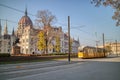 Square before Hungarian paliament building with moving tram in Budapest.