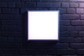 Square Illuminated Frame Mounted on Dark Brick Wall Royalty Free Stock Photo