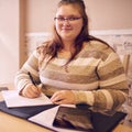 Square image of young overweight teenage girl looking at camera