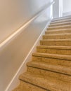 Square Interior of a house with a staircase covered with brown carpet Royalty Free Stock Photo