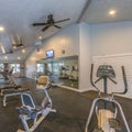 Square Interior of a spacious fitness gym with various exercise equipment