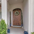 Square Inviting entrance path of a house with decorated wooden front door Royalty Free Stock Photo