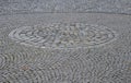 Square with a large dark gray circle inside a small round of cobblestone cubes. the stone is granite and basalt. a court of honor Royalty Free Stock Photo