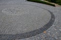 Square with a large dark gray circle inside a small round of cobblestone cubes. the stone is granite and basalt. a court of honor Royalty Free Stock Photo