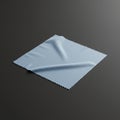Square light blue microfiber cloth with serrated edges on a dark grey surface. The clot Royalty Free Stock Photo