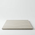 A square, light gray concrete slab sits against a plain white background. The surface Royalty Free Stock Photo