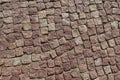 Square lined with cobblestone or stone pavement, walkway or road.