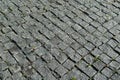 Square lined with cobblestone or stone pavement, walkway or road.