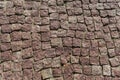 Square lined with cobblestone or stone pavement, walkway or road.