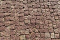 Square lined with cobblestone or stone pavement, walkway or road.