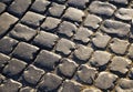 Square lined with cobblestone or stone pavement, walkway or road. The surface of rough stones and rough. The cobbles Royalty Free Stock Photo