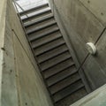 Square Looking down on staircase with metal handrails inside of commercial building Royalty Free Stock Photo