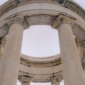Square Looking up at a white circular structure supported by smooth columns