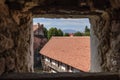 Through square loophole of Prejmer fortified church wall, Transylvanian beautiful panoramic view opens Royalty Free Stock Photo