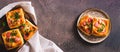 Square mini pie baked with tomato, sausage and cheese on a plate for a snack top view web banner