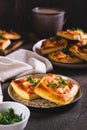 Square mini pizza with tomato, sausage and cheese on a plate for a snack vertical view