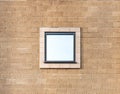 square mirror reflective window centred on a brick wall Royalty Free Stock Photo