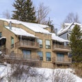 Square Mountain homes in Park City Utah with snow and icicles on roofs in winter Royalty Free Stock Photo