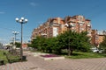 The square named after the polar pilot Vasily Molokov against the background of a residential building on a sunny summer day