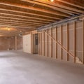 Square New home interior under construction with the wood framing visible Royalty Free Stock Photo