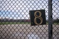 A square number eight tag is attached to the chain link fence and clearly visible Royalty Free Stock Photo