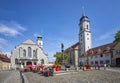 The square old town with authentic traditional house tower from church and paving stones.