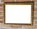 Square old vintage golden blank painting frame work hanging on a brick wall close up Royalty Free Stock Photo