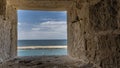 Through a square opening in the wall of the Citadel of Qaitbay in Alexandria, you can see the blue sky Royalty Free Stock Photo