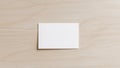 Square Paper on Wooden Surface, Minimalist Composition with Warm Tones and Texture. Royalty Free Stock Photo