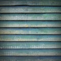 Square part of shed wall consisting of old wooden planks with faded green paint Royalty Free Stock Photo