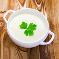 Square photo of potato and onion vegan, vegetarian healthy cream soup in white ceramic bowl. Top view. Tasty potato soup with a le Royalty Free Stock Photo