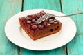 Square piece of homemade yummy chocolate cake with cherries with