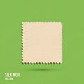 The fabric is a light beige color set against a solid green background. Royalty Free Stock Photo