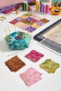 Square pieces of colorful bright fabrics for making quilt, pincushion, quilting block, sewing and quilting accessories