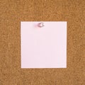 Square pink blank note paper pinned to corkboard Royalty Free Stock Photo