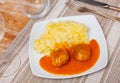 on square plate creamy mashed potatoes with round minced chicken meatballs with tomato sauce Royalty Free Stock Photo