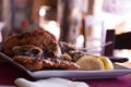 Square Plate with Roasted Meat and Lemons