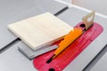 square plate, tools, lying on a machine circular saw in a workshop woodworking. Royalty Free Stock Photo