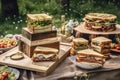 square plates with towering sandwiches and delicate pastries for rustic-chic picnic