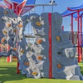 Square Playground equipment at a park under blue sky on a sunny day