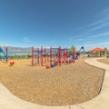 Square Playground and pavilion at a park with lake and snow capped mountain bakcground