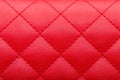 Square red leather pattern stitched with thread seam.