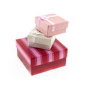 Square red and pink striped giftbox with gray and cream mini polar on an isolated background Royalty Free Stock Photo