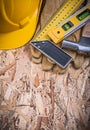 Square ruler construction level hammer yellow hard hat leather g Royalty Free Stock Photo