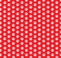 Square seamless pattern of white animal paw prints on red background.