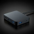 Square-shaped black USB hub with rounded edges on a dark background. Features Royalty Free Stock Photo