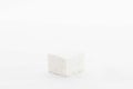 a square stone that is on top of a white surface Royalty Free Stock Photo